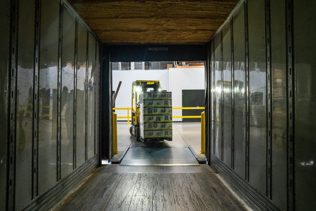 Forklift loading a semi-trailer at a Farmington Hills warehouse, a common site of Michigan workers' compensation accidents.